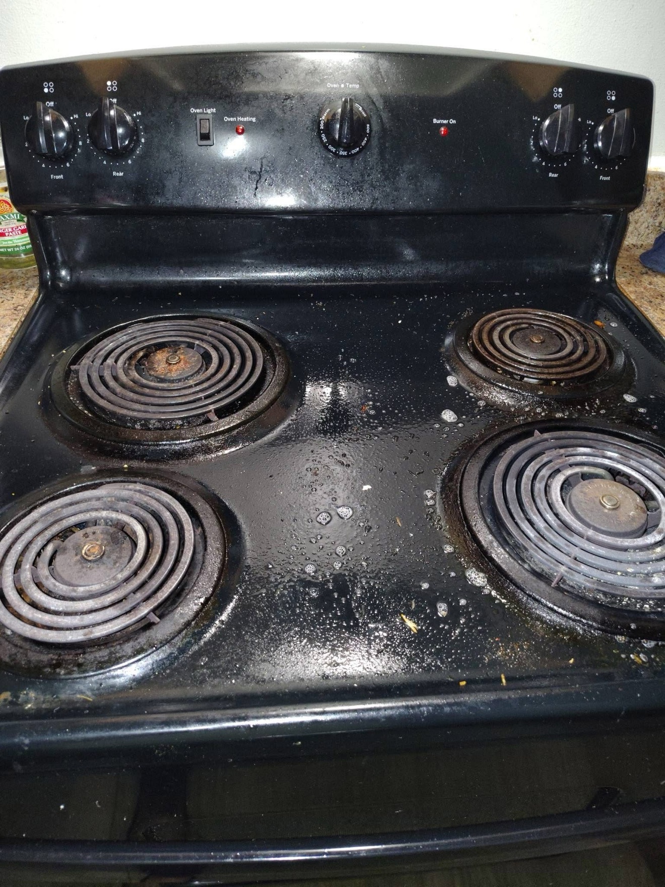 Greasy stovetop before deep cleaning