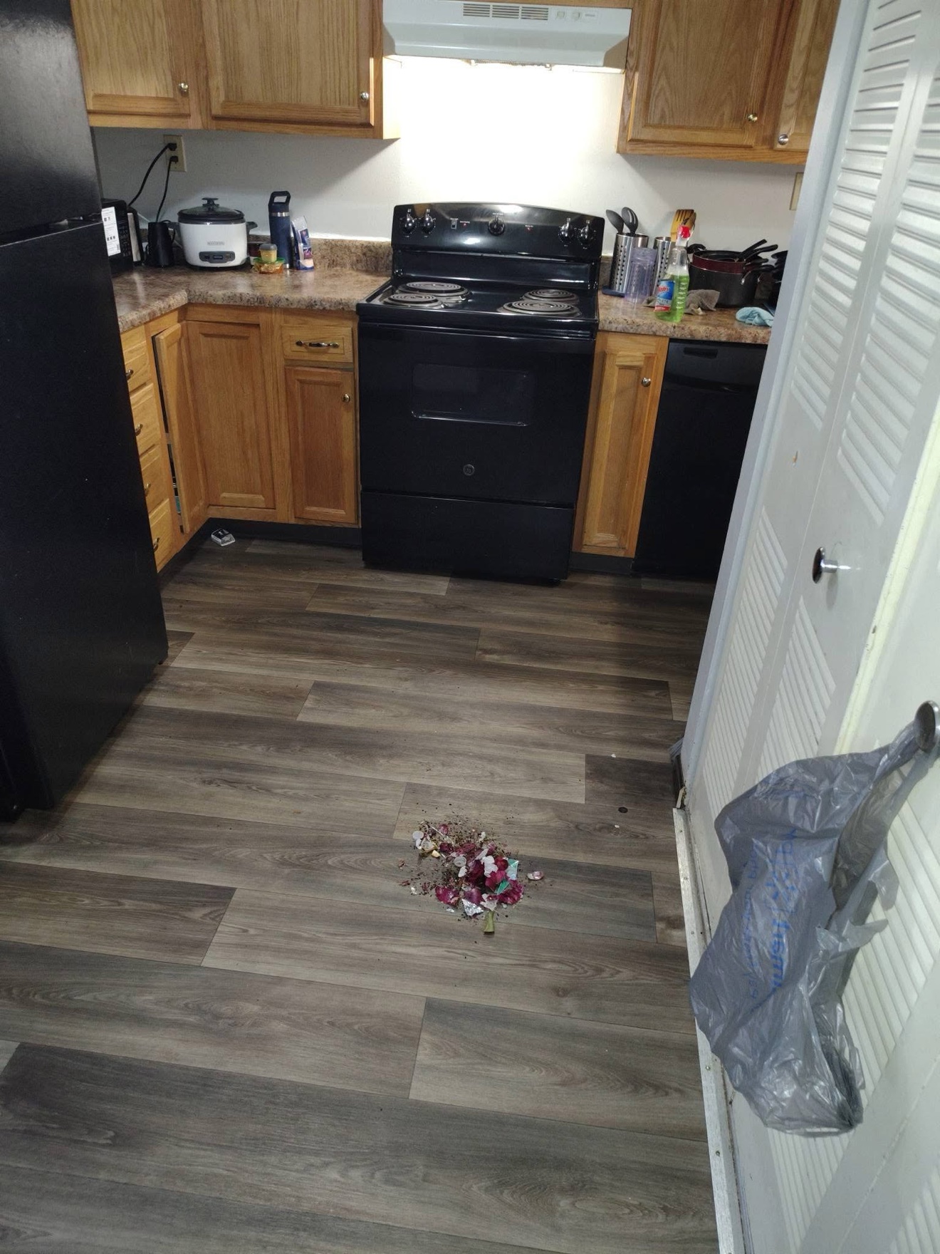 Kitchen floor with debris before deep cleaning